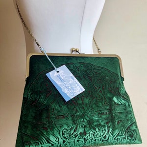 Deep green celtic embossed velvet Kisslock handbag purse with an iridescent red accent.