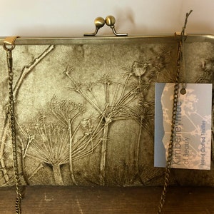 Embossed velvet kisslock clutch bag purse with a foliage cow parsley design in a sagey green gold colour