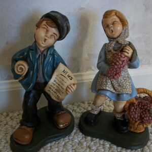 Chalk ware made in the 50’s or early 60’s Statues of a Boy and Girl Hawking Newspapers & Fruit (#0126)