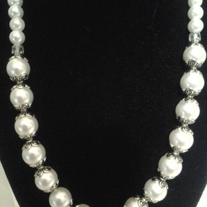 Cosmetic pearl set back view available this set consist of  necklace, earrings, and bracelet.