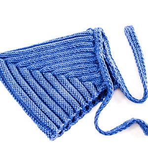 May include: A blue knitted hat with a long tie. The hat is made of a soft, textured yarn and has a simple, classic design.