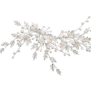 May include: A silver hair comb with a floral design and pearl accents. The comb is made of metal and has a delicate, intricate design.