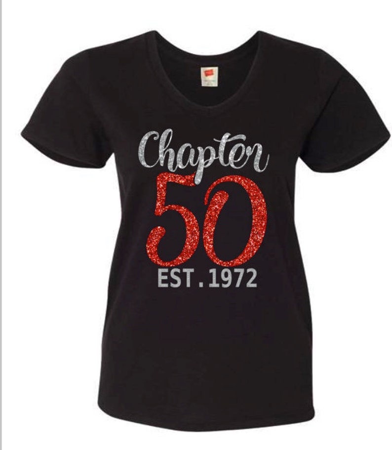 May include: Black v-neck t-shirt with silver glitter text that reads "Chapter 50 EST. 1972" and a large red glitter number 50.