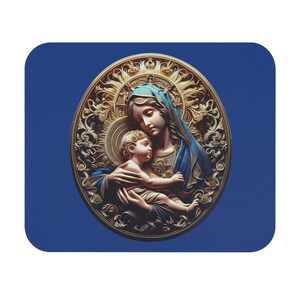 May include: A religious-themed mousepad featuring a detailed illustration of the Virgin Mary holding baby Jesus. The image is set within an ornate gold frame against a deep blue background. The figures are depicted with soft colors and intricate details.