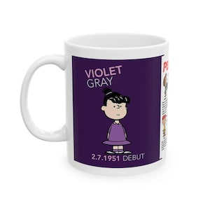 May include: White ceramic mug featuring a cartoon image of Violet Gray in a purple dress, with the text "VIOLET GRAY" and "2.7.1951 DEBUT" on a purple background. The mug has a white handle and a list of characters on the side.