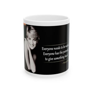 May include: A white ceramic mug with a black background featuring a black and white photo of Princess Diana. The quote "Everyone needs to be valued. Everyone has the potential to give something back. - Princess Diana" is printed in gold lettering.