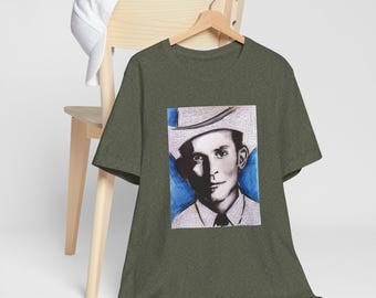 May include: A dark green t-shirt with a white and blue illustration of a man wearing a cowboy hat. The man has a serious expression on his face.