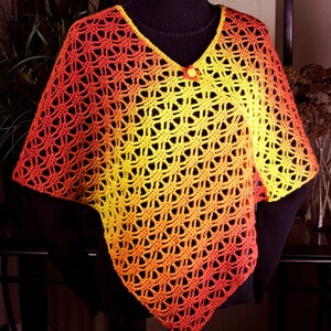 May include: A crocheted poncho with a gradient of orange, yellow, and red. The poncho has a v-neck and a button closure.