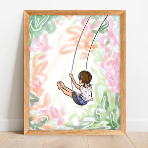 May include: A framed art print featuring a whimsical illustration of a child on a swing. The artwork has a light color palette with a background of abstract floral shapes in pink, green, and orange. The frame is made of light-colored wood.