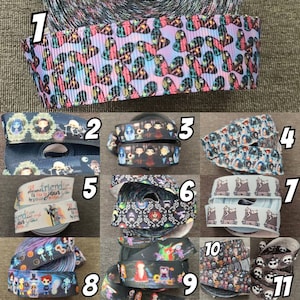 May include: A collection of 11 different ribbon rolls featuring characters from the movie "The Nightmare Before Christmas". The ribbons are black, white, and gray with various patterns and designs. The ribbons are numbered 1 through 11.