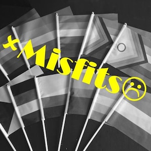 May include: A collection of small handheld flags arranged in a fan shape, each attached to a white plastic pole. The image is in black and white, featuring the bright yellow text +MISFITS and a sad face emoji overlaid across the center.