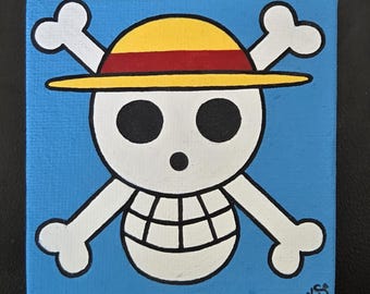May include: Square canvas art featuring a white skull with crossed bones, wearing a yellow straw hat with a red band, set against a light blue background. The artwork is signed with the initials "KS" in the lower right corner.