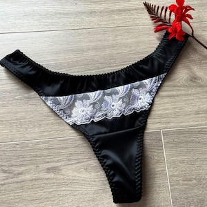 Womens black satin thong with white lace detailing. Bella black and white thong, available in plus size UK6-UK22