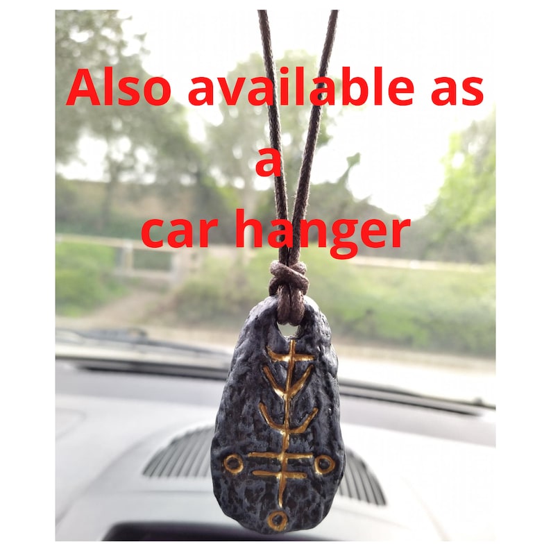 May include: A black and gold pendant with a symbol on it, hanging from a brown cord. Also available as a car hanger.