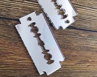 A pair of laser cut acrylic razor blade charms in a mirrored finish, option to add words
