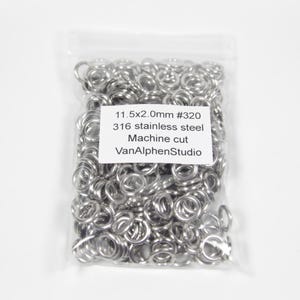 May include: A transparent bag containing many small, silver metal rings. A white label shows text: "11.5x2.0mm #320 316 stainless steel Machine cut VanAlphenStudio."