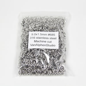 May include: A clear plastic bag filled with numerous small, shiny, silver-colored metal rings. The rings are machine cut and made of 316 stainless steel. Text on the label reads "9.0x1.5mm #685" and "VanAlphenStudio".