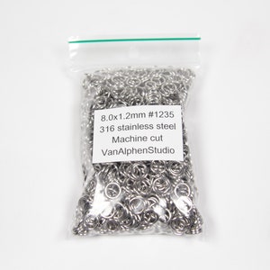May include: A bag of silver jump rings, 8.0x1.2mm in size, made of 316 stainless steel. The label reads "8.0x1.2mm #1235 316 stainless steel Machine cut VanAlphenStudio".