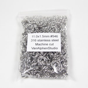 May include: A transparent bag containing a multitude of small, bright, silver metal rings. The bag features a white label with black text: "11.0x1.5mm #546 316 stainless steel Machine cut VanAlphenStudio."