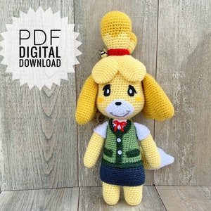 Peut inclure: Un modèle de crochet pour un personnage de chien jaune et brun avec un gilet vert et une jupe bleue. Le modèle est un téléchargement numérique au format PDF.
