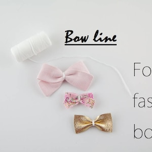 May include: Three bows, one pink, one floral print, and one gold, with white thread and the text "Bow line for faster bows".
