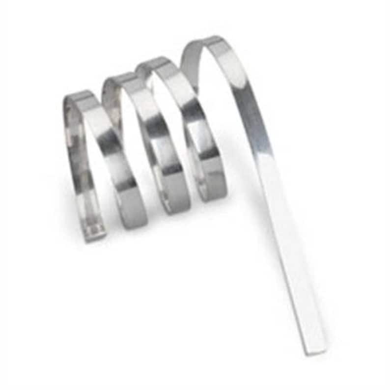 May include: A coil of silver-colored metal wire. The wire is thin and flexible, and it is coiled into a tight spiral.