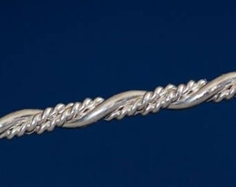 May include: A silver twisted bangle bracelet. The bracelet is made of a thick, twisted wire that is polished to a shine.