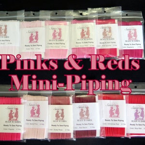 May include: A collection of 10 small packages of pink and red ready-to-sew piping. Each package contains 3 yards of piping and is labeled with the color name and "Susie's Ready to Smok".