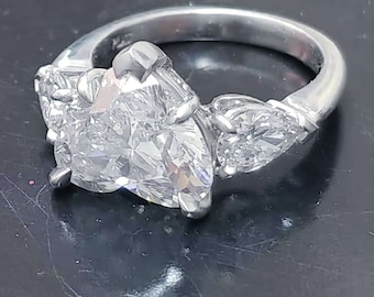Platinum handmade ring with heart shaped diamond center