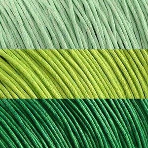 May include: Three spools of waxed cotton cord in different shades of green. The top spool is a light green, the middle spool is a bright green, and the bottom spool is a dark green.