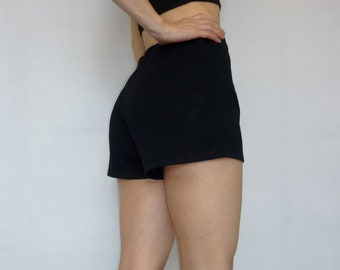 May include: Black shorts with a high waist and a relaxed fit. The shorts are made of a soft, comfortable fabric.