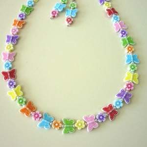 May include: A rainbow-colored necklace with butterfly charms and small flower beads. The necklace is made of plastic and is approximately 18 inches long.
