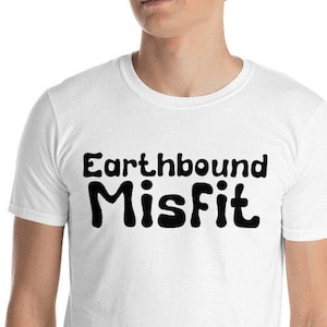 May include: White t-shirt with black text that reads "Earthbound Misfit".