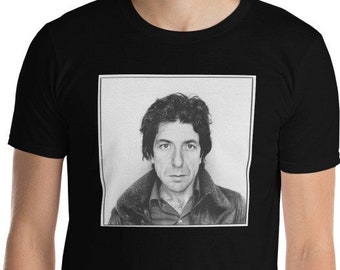 May include: A black t-shirt with a white square image of a man with dark hair and a serious expression. The man is wearing a brown jacket and a light-colored shirt.