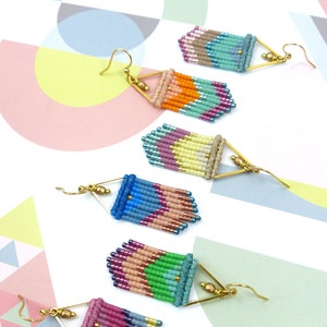May include: Five pairs of colourful beaded earrings with gold triangle accents. Each pair features a different colour combination of beads, including pink, blue, green, orange, and brown.