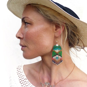 Statement beaded fringe earrings with eyes patterns blue green and fuchsia pink