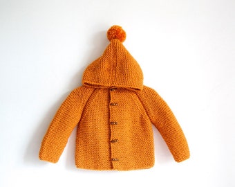 Hand Knitted baby wool hoodie cardigan/Jacket, Chunky, Duffel Coat, Raglan with pom pom, picture color bitter orange