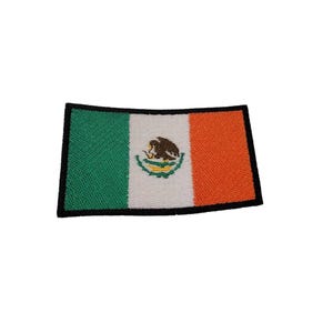 May include: An embroidered patch of the Mexican flag. The flag is green, white, and orange with the Mexican coat of arms in the center.