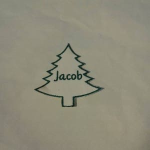 Pode incluir: Um contorno preto simples de uma árvore de Natal com o nome "Jacob" escrito dentro.