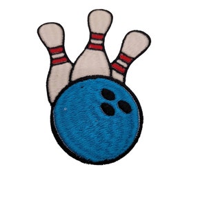 May include: A blue bowling ball with three white bowling pins with red stripes behind it. The bowling pins are knocked down.