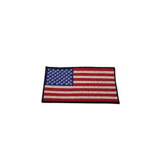 May include: A small embroidered American flag patch with a black border. The flag is red, white, and blue.