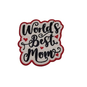 May include: White embroidered patch with red stitching. The patch features the text "World's Best Mom" in black cursive lettering with small red hearts.