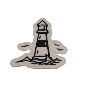 May include: A black and white embroidered patch of a lighthouse with birds flying overhead. The lighthouse is on a wave with a white background.
