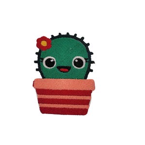 May include: A green cactus with a red flower and a happy face is potted in a red and pink striped pot.