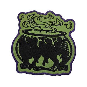 May include: An embroidered patch featuring a green and black cauldron with steam rising from it. The cauldron is on a fire and has a purple outline.