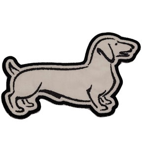 Puede incluir: Un parche bordado en blanco y negro de un perro salchicha.