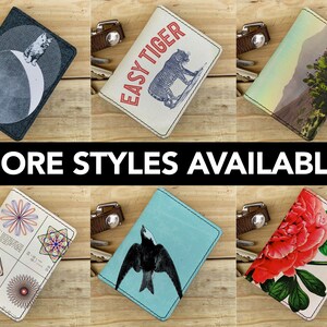 May include: Six different leather card holders with various designs. The designs include a moon and stars, a tiger, a desert landscape, a geometric pattern, a bird, and a flower.