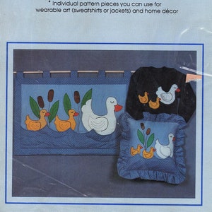 May include: A craft pattern for sewing appliques of swimming ducks. The pattern includes instructions for making a pillow, a wall hanging, and a sweatshirt or jacket. The pattern is called "Buildables" and is project number HP70.