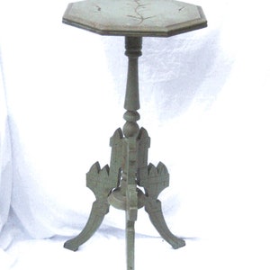 May include: A green painted wooden side table with a hexagonal top and a carved, three-legged base.