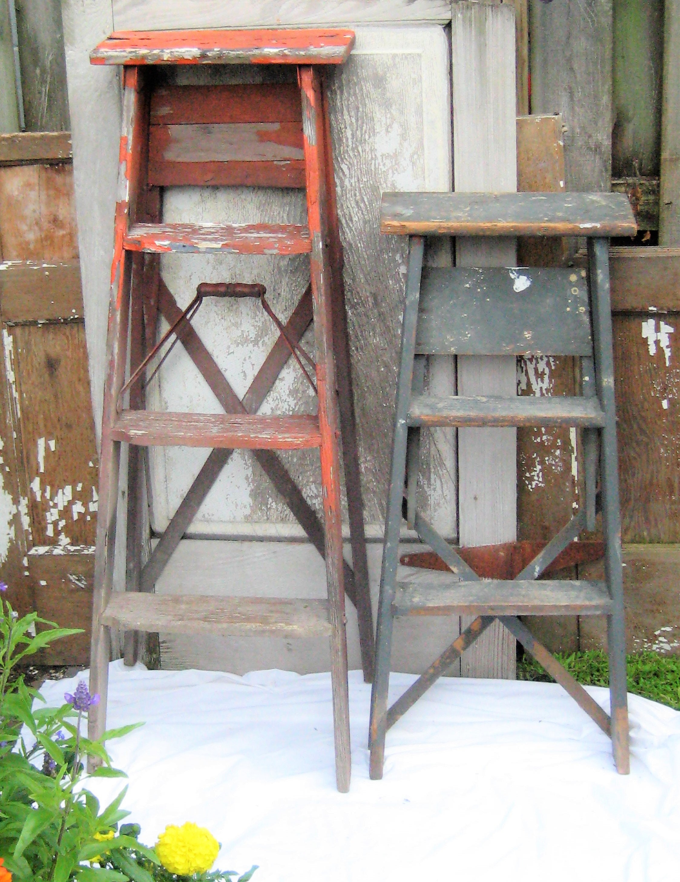 Old vintage wooden step ladder with paint splatters, display